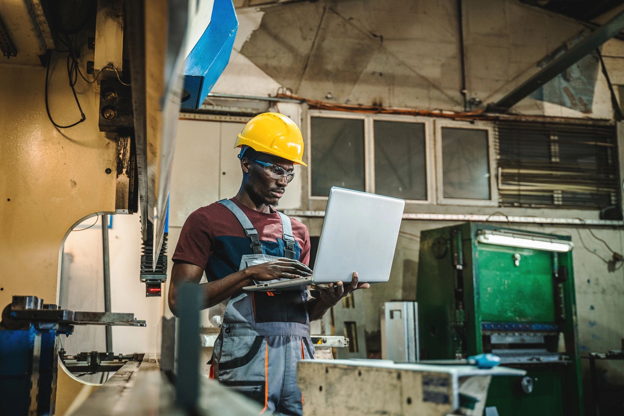 Technician reviewing industrial machine performance in a factory
