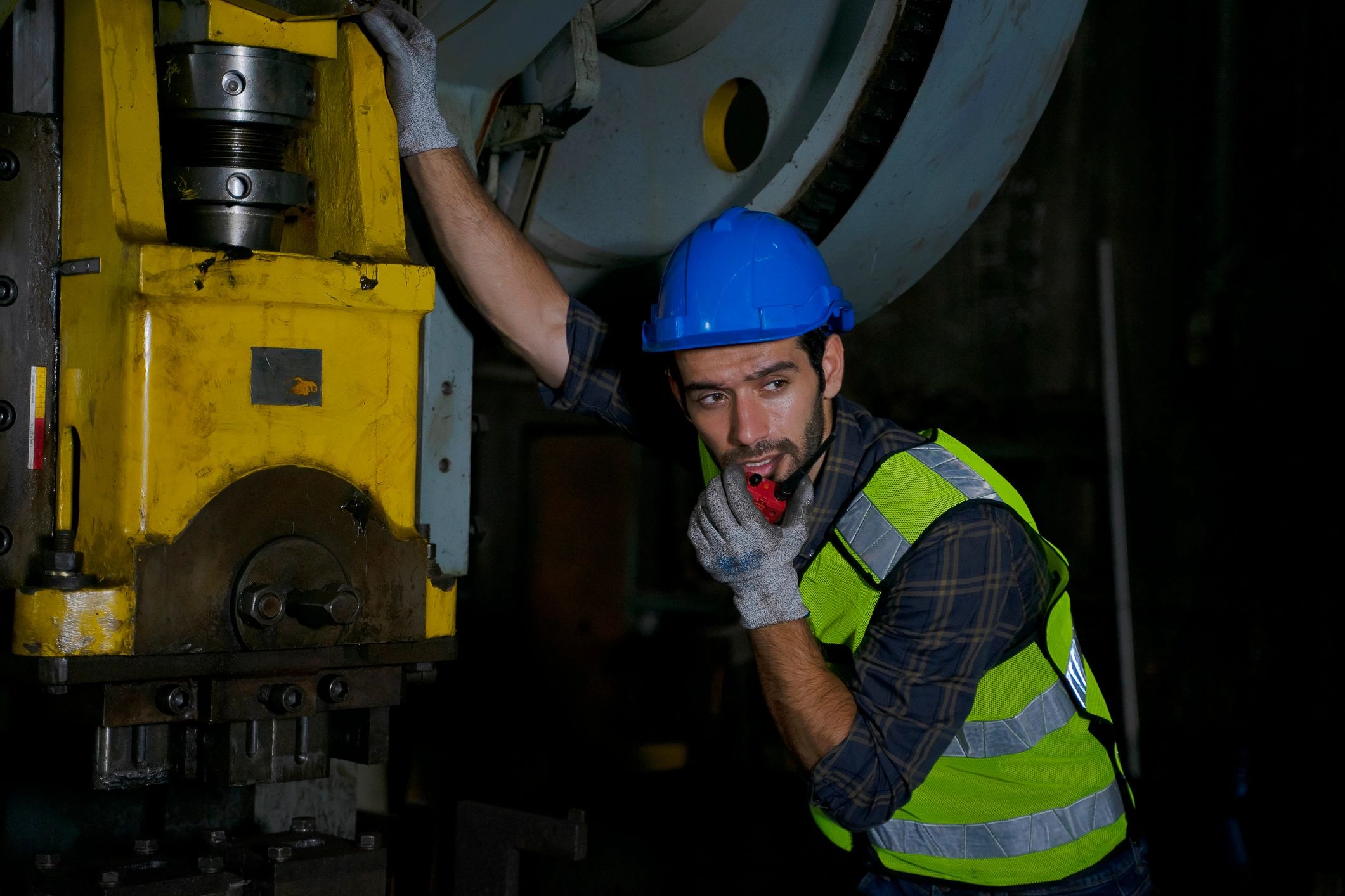 Engineer working at industrial machinery