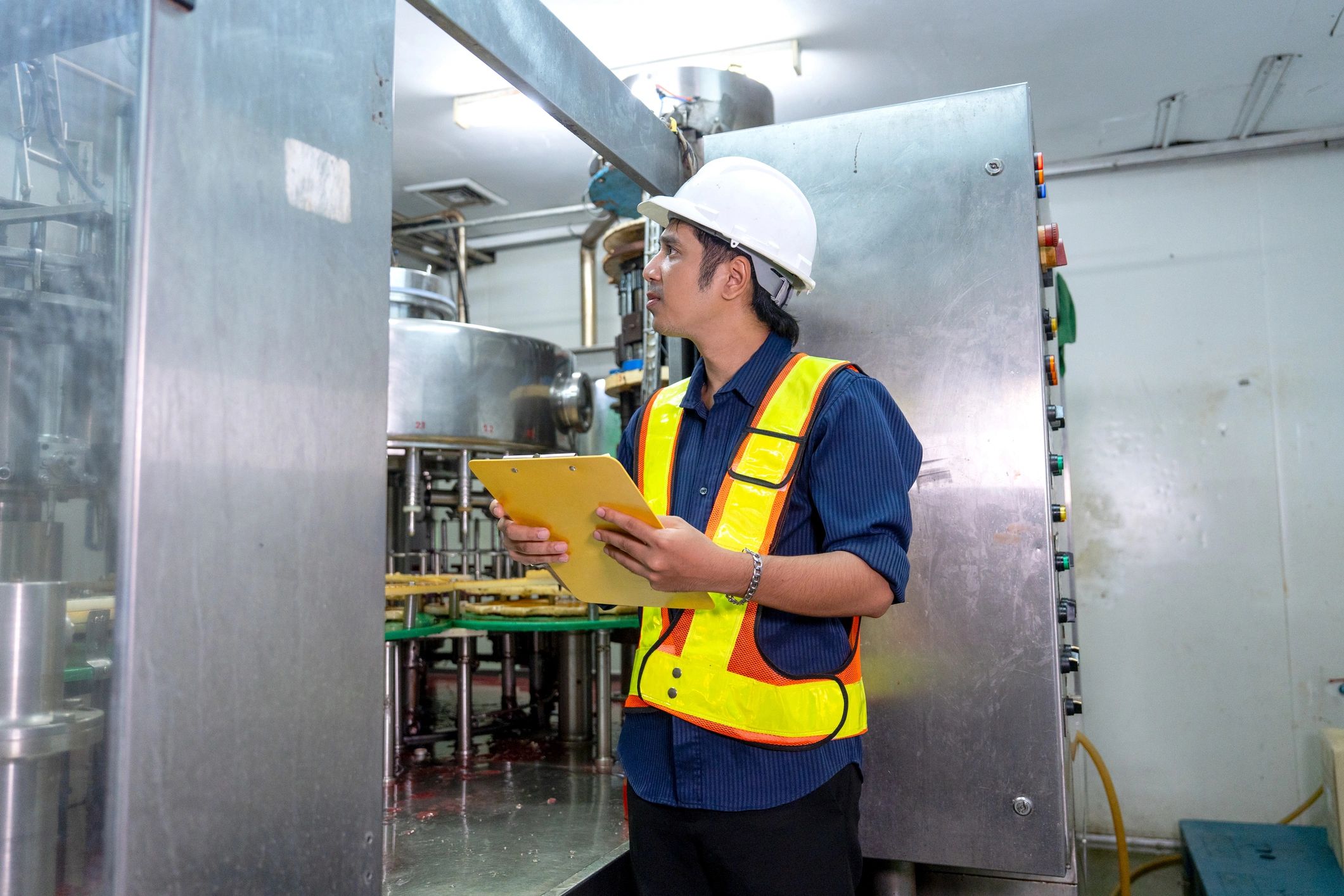 Industrial engineer inspecting machinery in a factory